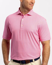 Man wearing a pink polo shirt on a white background