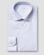Light blue dress shirt with a subtle pattern on a light gray background, featuring the Eton brand.