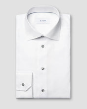 White dress shirt with cufflinks on a light gray background, featuring the Eton brand.