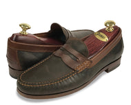 A pair of Johnston & Murphy brown leather loafers with suede detailing, displayed on a white background.
