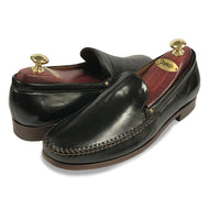 A pair of black Johnston & Murphy Seth loafers with visible stitching and metal eyelets on a white background.
