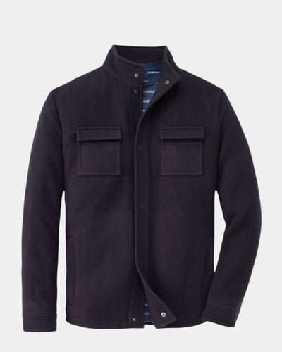 A navy blue wool blend stable shirt jacket with a stand-up collar, two chest pockets, and besom side-entry pockets with snap closure.